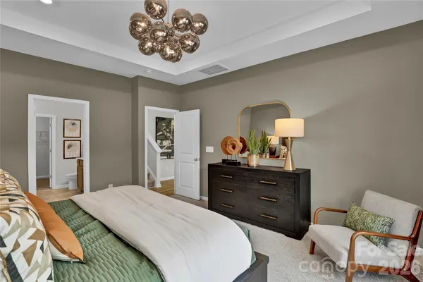 a bedroom with a bed and a dresser in it
