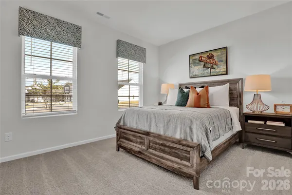 a bed sitting in a bedroom next to a window