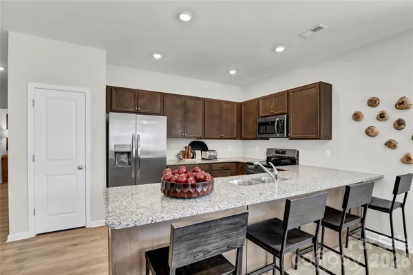 a kitchen with a sink cabinets and wooden floor