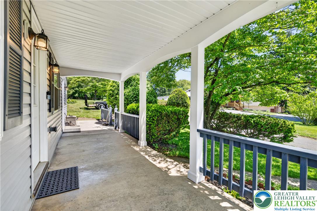 1411 Lieb Road Easton, PA 18040 - Photo 14 of 46 A welcoming front porch provides a pleasant entry, overlooking lush green landscaping.