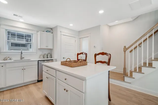 a view of a kitchen center island and living room