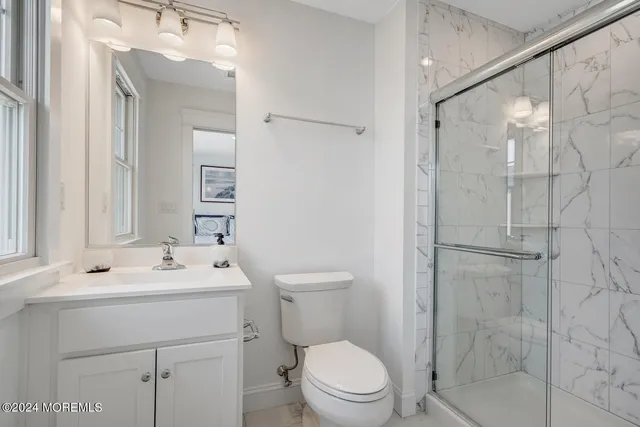 a bathroom with a sink mirror and vanity