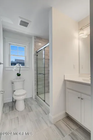 a bathroom with a shower and a toilet