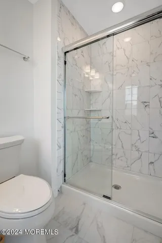 a front view of a house with a road