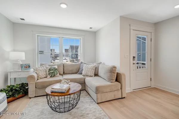 a kitchen with a refrigerator a stove a dining table and chairs next to a window
