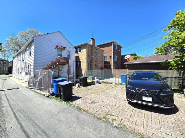 a wooden bench sitting in front of a building