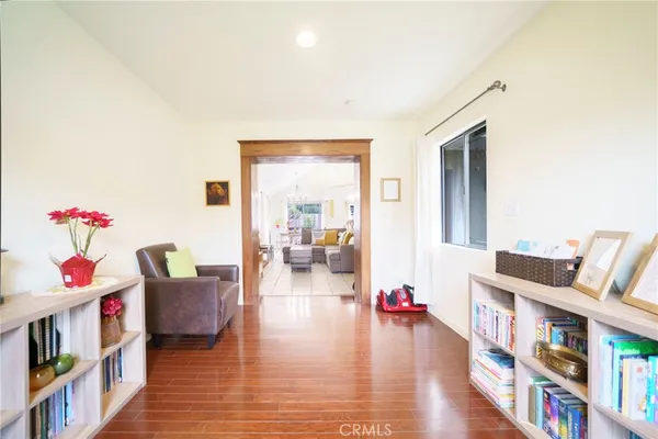a living room with furniture and a book shelf