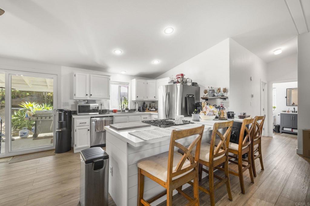 224 Astro Court Vista, CA 92083 - Photo 20 of 47 a kitchen with a table and chairs in it