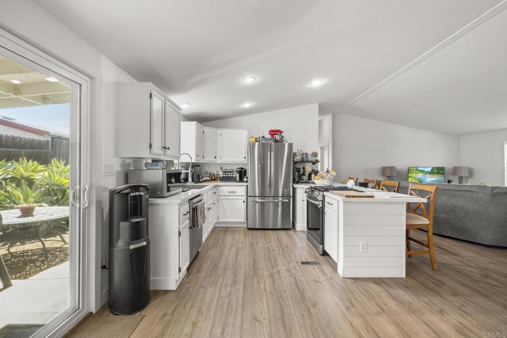 224 Astro Court Vista, CA 92083 - Photo 21 of 47 a kitchen with refrigerator and cabinets