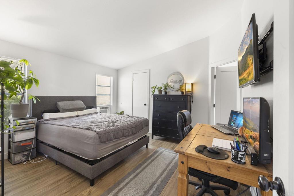 224 Astro Court Vista, CA 92083 - Photo 26 of 47 a bedroom with a bed and a flat screen tv
