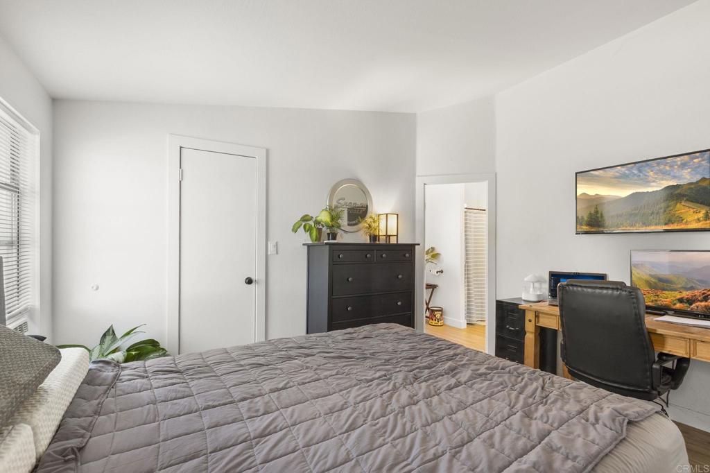 224 Astro Court Vista, CA 92083 - Photo 27 of 47 a bedroom with a bed and a chandelier