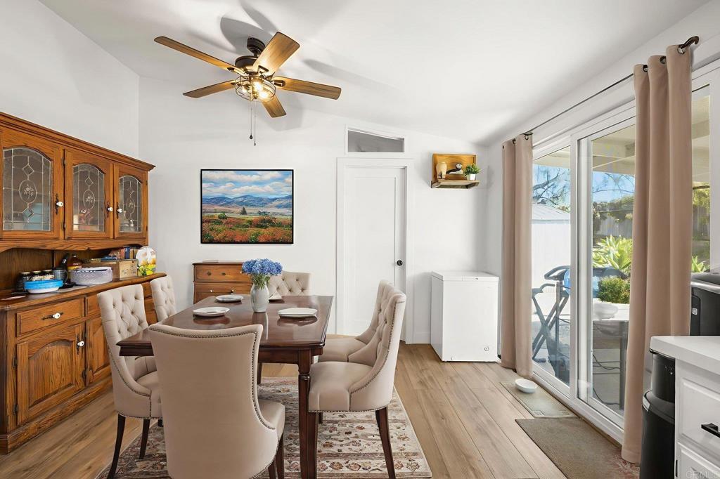 224 Astro Court Vista, CA 92083 - Photo 31 of 47 a view of a dining room with furniture a chandelier and wooden floor