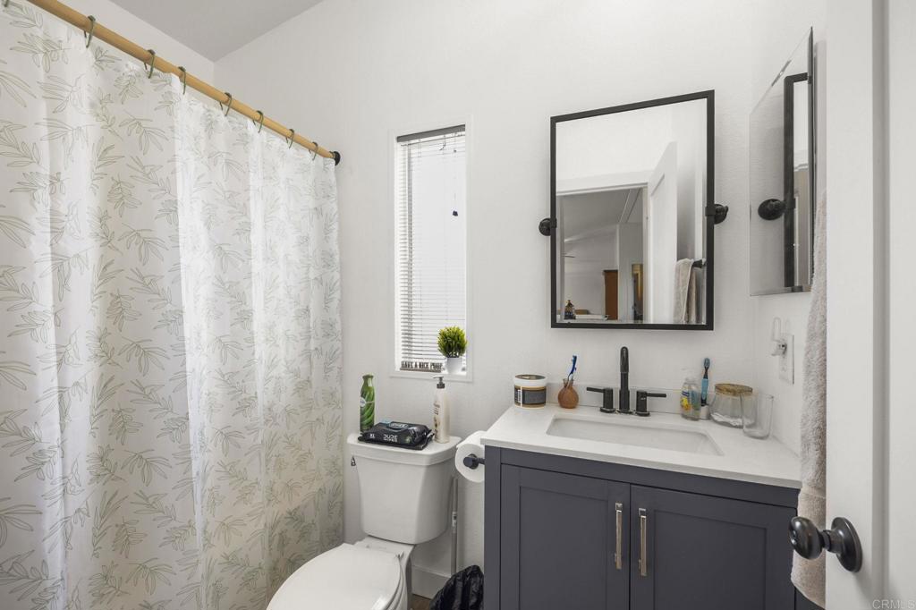 224 Astro Court Vista, CA 92083 - Photo 33 of 47 a bathroom with a granite countertop sink toilet and mirror