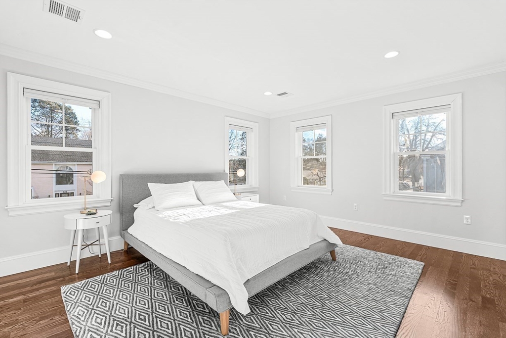 25 Cavanaugh Path Newton, MA 02459 - Photo 18 of 31 a bed sitting in a bedroom next to a window