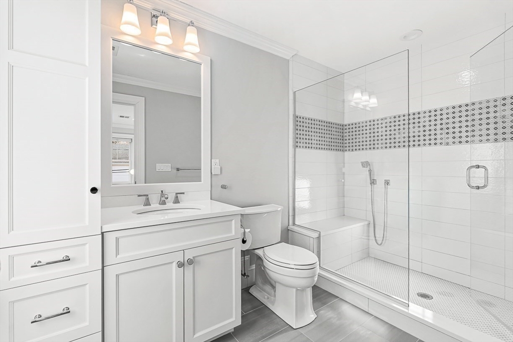 25 Cavanaugh Path Newton, MA 02459 - Photo 19 of 31 a bathroom with a toilet sink a shower and