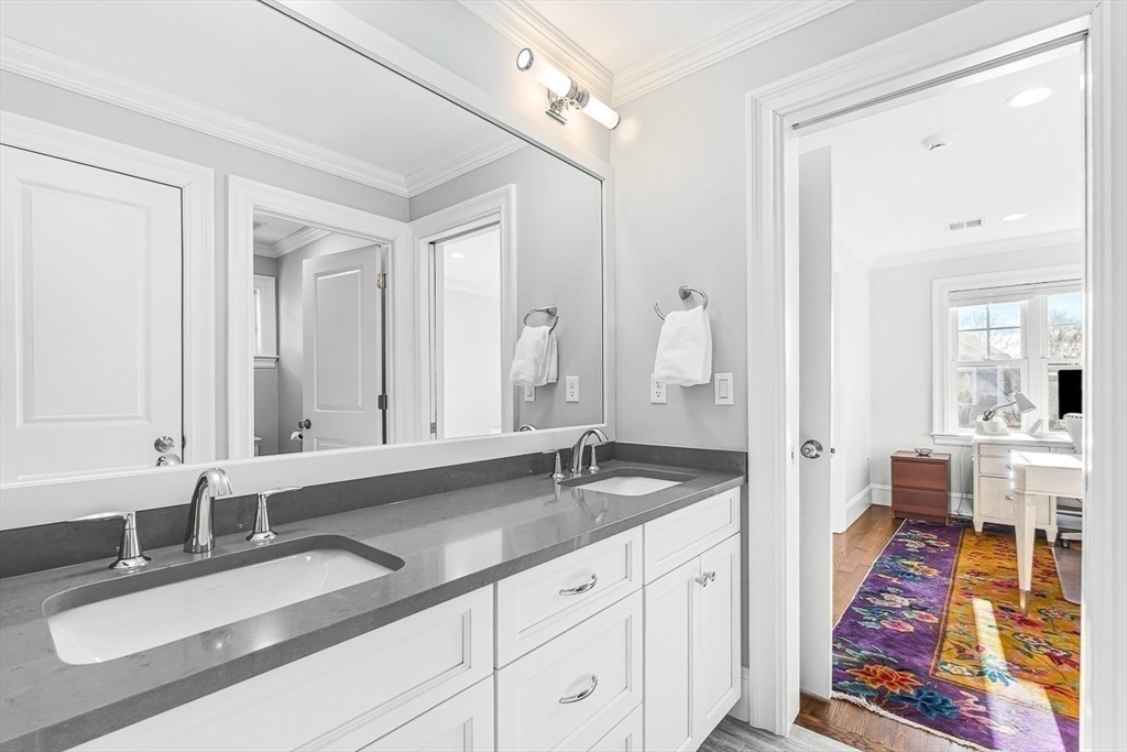 25 Cavanaugh Path Newton, MA 02459 - Photo 21 of 31 a en suite bathroom with double sink and a mirror