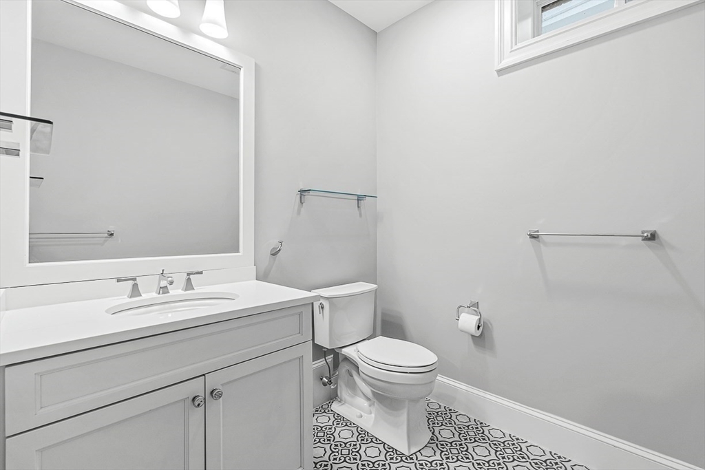 25 Cavanaugh Path Newton, MA 02459 - Photo 25 of 31 a bathroom with a toilet sink and mirror