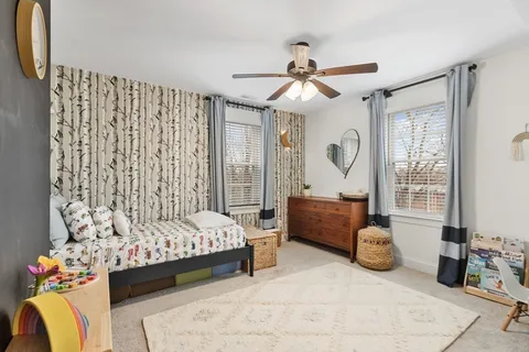 a bedroom with bed and a chandelier