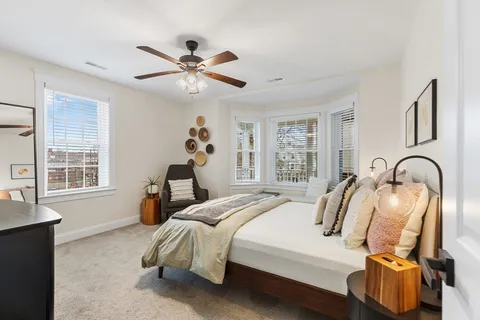 a bedroom with a bed and window
