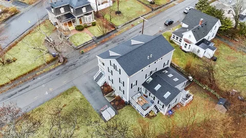 an aerial view of a house with a swimming pool