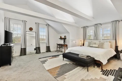 a bed room with a bed and a television