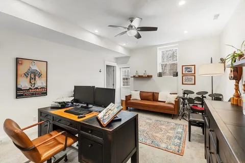 a living room with furniture and a desk