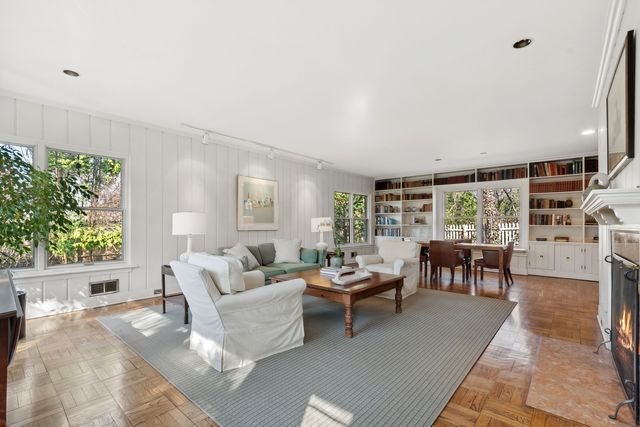 a dining room with furniture and wooden floor