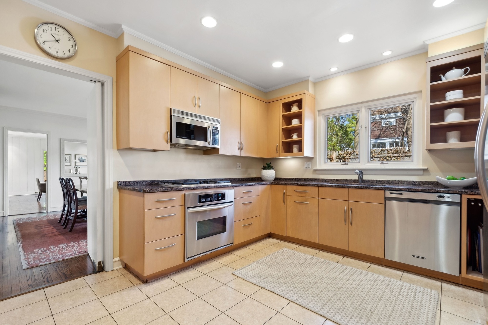 618 Ridge Road Winnetka, IL 60093 - Photo 15 of 29 a kitchen with stainless steel appliances granite countertop a stove top oven a sink and a microwave