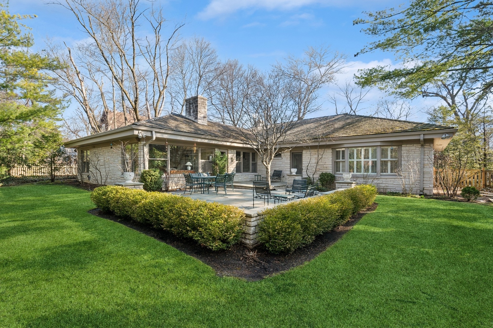 618 Ridge Road Winnetka, IL 60093 - Photo 2 of 29 a front view of a house with a yard table and chairs