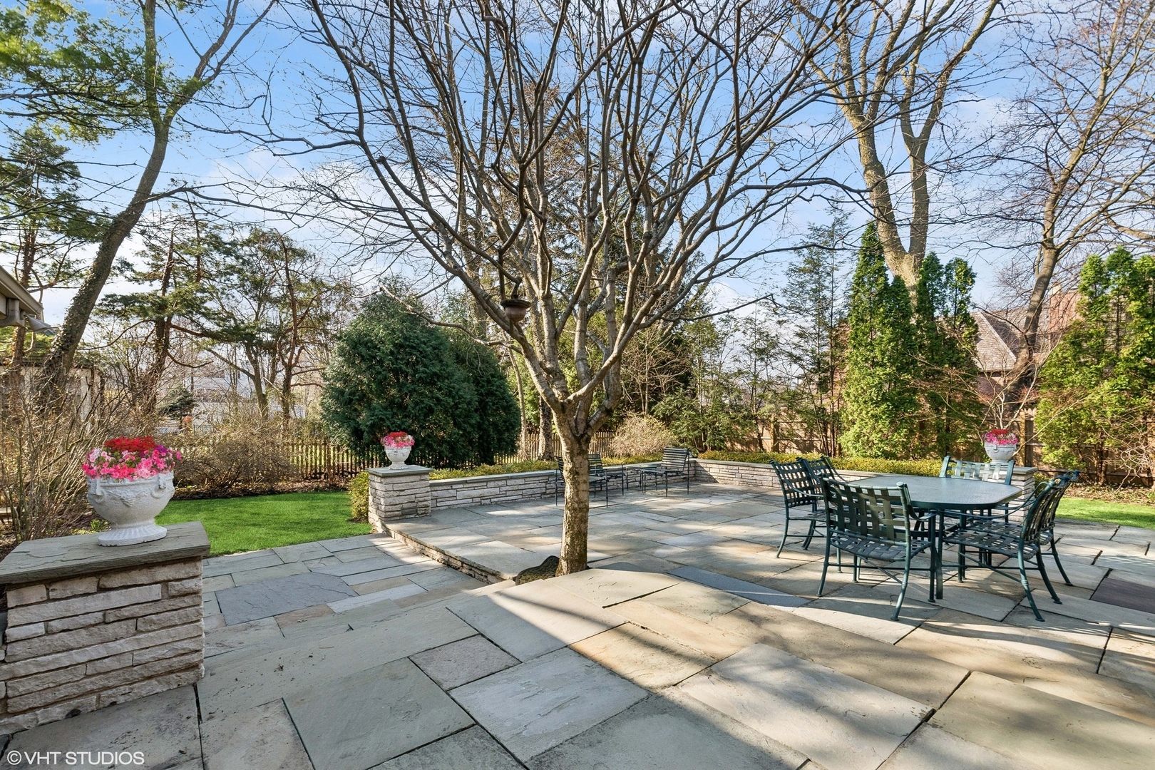 618 Ridge Road Winnetka, IL 60093 - Photo 3 of 29 a view of a patio with table and chairs and a large tree