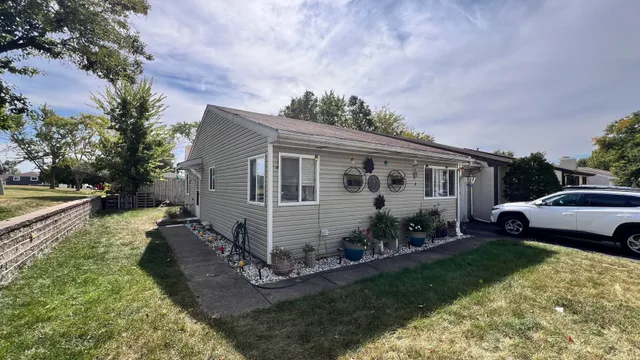 a view of a house with backyard sitting area and garden