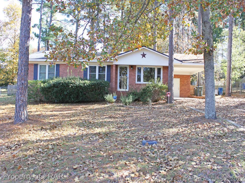 7621 Decatur Drive Fayetteville, NC 28303 - Photo 1 of 15 a front view of a house with yard and green space
