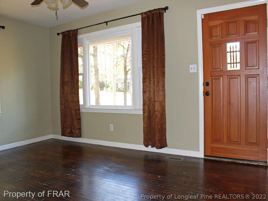 7621 Decatur Drive Fayetteville, NC 28303 - Photo 3 of 15 an empty room with wooden floor and windows