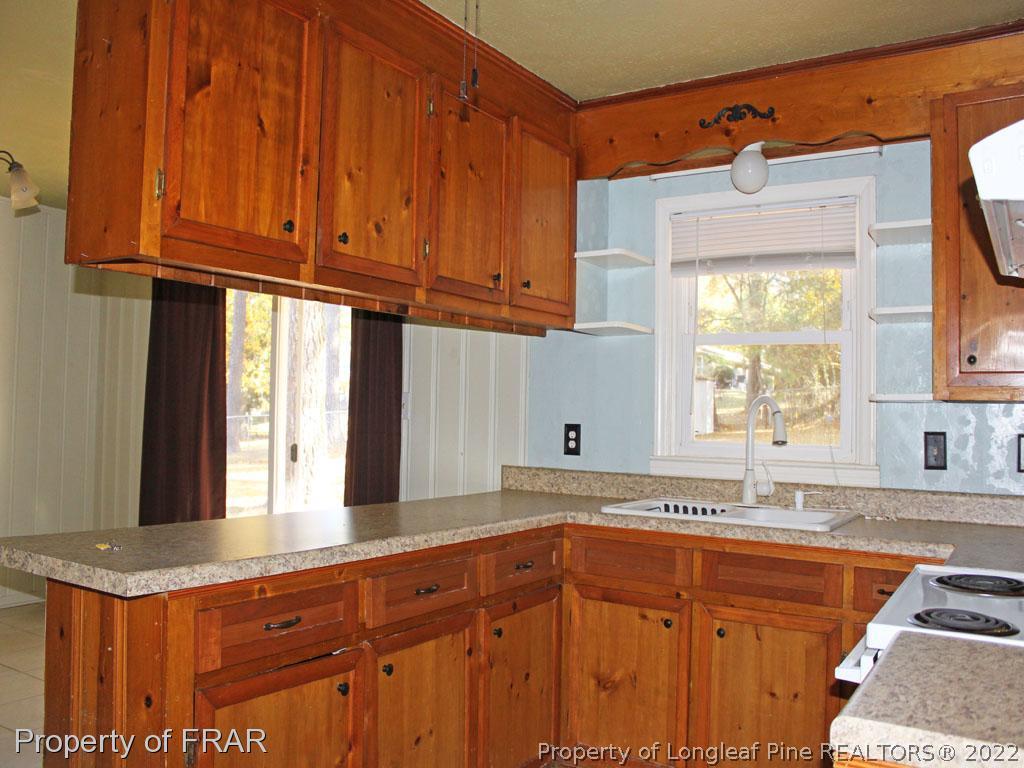 7621 Decatur Drive Fayetteville, NC 28303 - Photo 6 of 15 a kitchen with stainless steel appliances granite countertop a sink and a stove