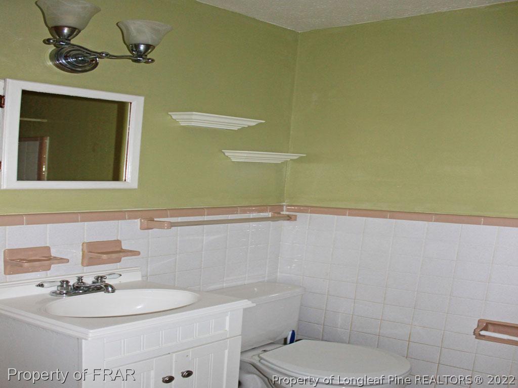 7621 Decatur Drive Fayetteville, NC 28303 - Photo 8 of 15 a bathroom with a sink a toilet and shower