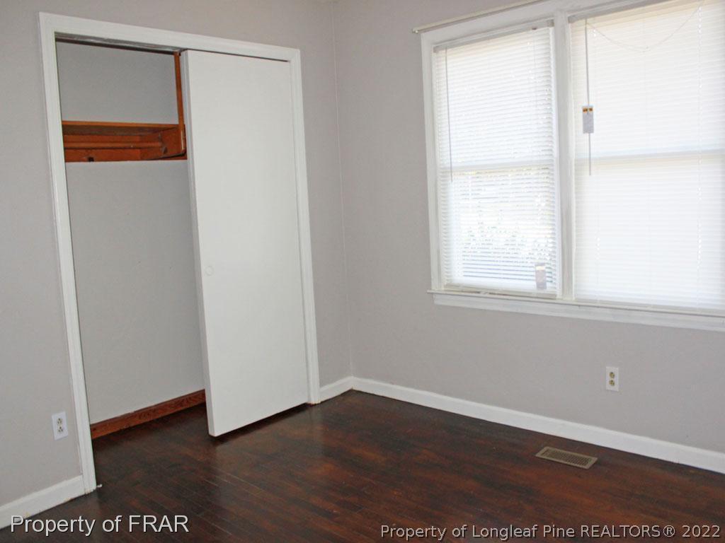 7621 Decatur Drive Fayetteville, NC 28303 - Photo 10 of 15 a view of an empty room with wooden floor and a window