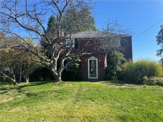 a view of a house with a tree