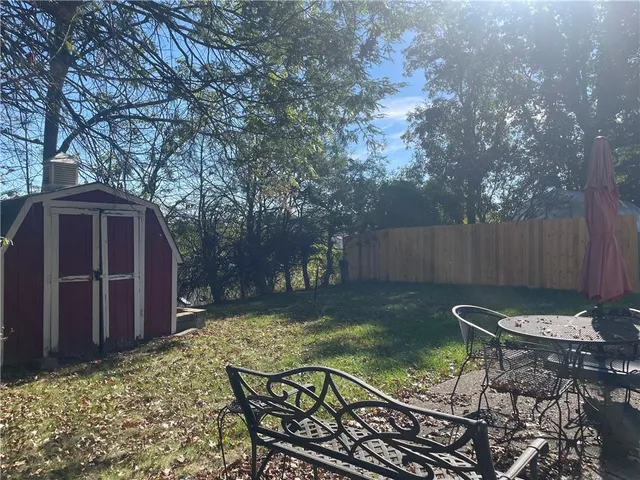 a view of a backyard with sitting area