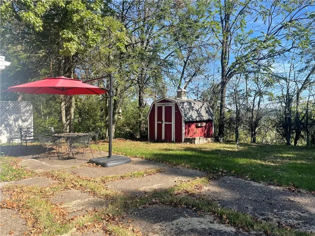 a backyard of a house with table and chairs