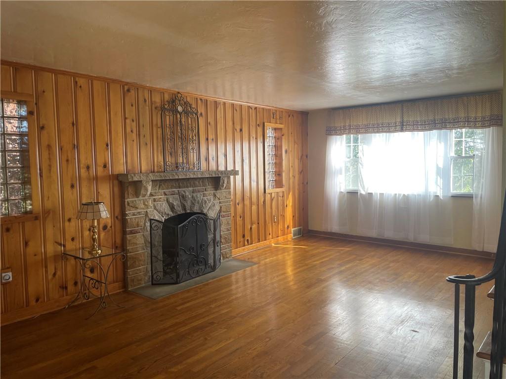 1018 Grandview Avenue Pittsburgh, PA 15237 - Photo 6 of 29 an empty room with wooden floor fireplace and windows