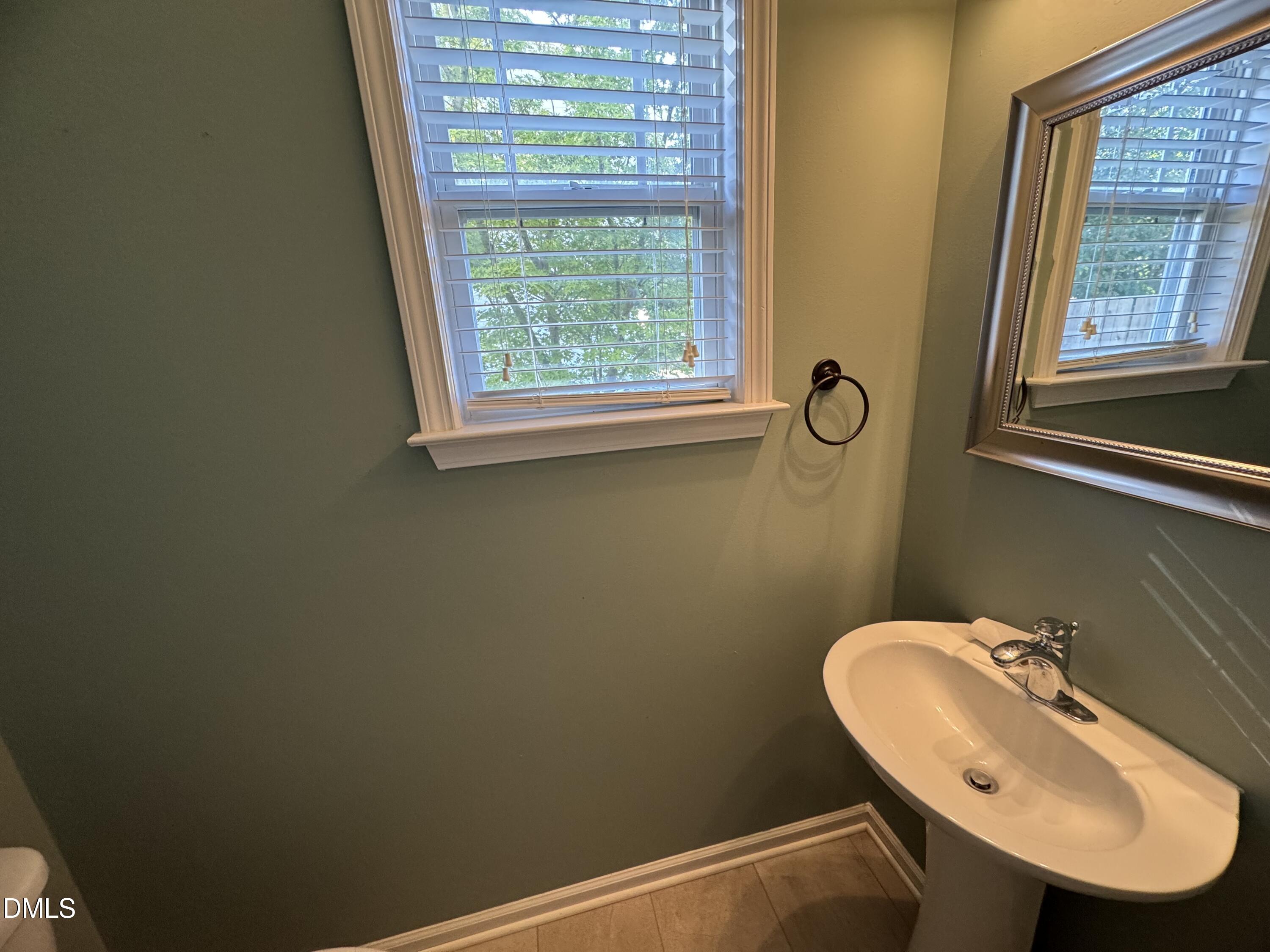 4008 Landover Lane Raleigh, NC 27616 - Photo 6 of 19 a bathroom with a sink and a mirror