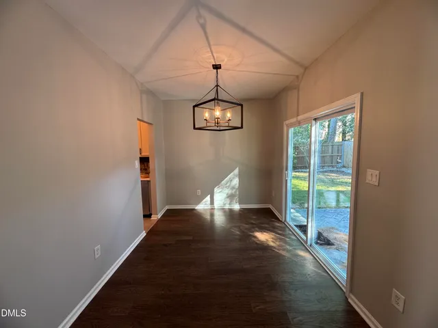 a kitchen with a refrigerator a stove cabinets and a counter top space