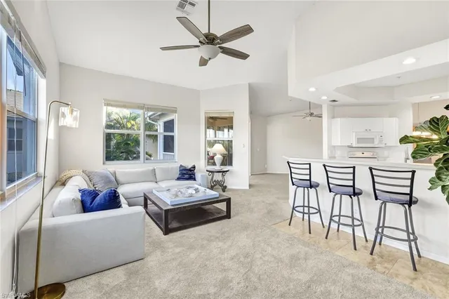 a kitchen with kitchen island white cabinets and a sink