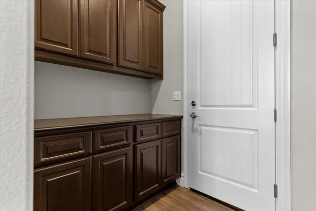a view of a closet with wooden floor