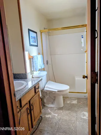 a bathroom with a toilet a sink and a shower
