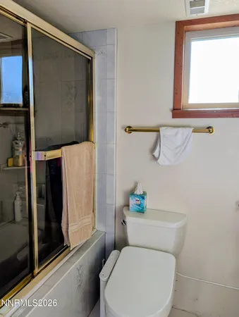 a bedroom with a bed and painting on the wall