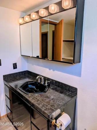 a view of a dry yard with mountains in the background