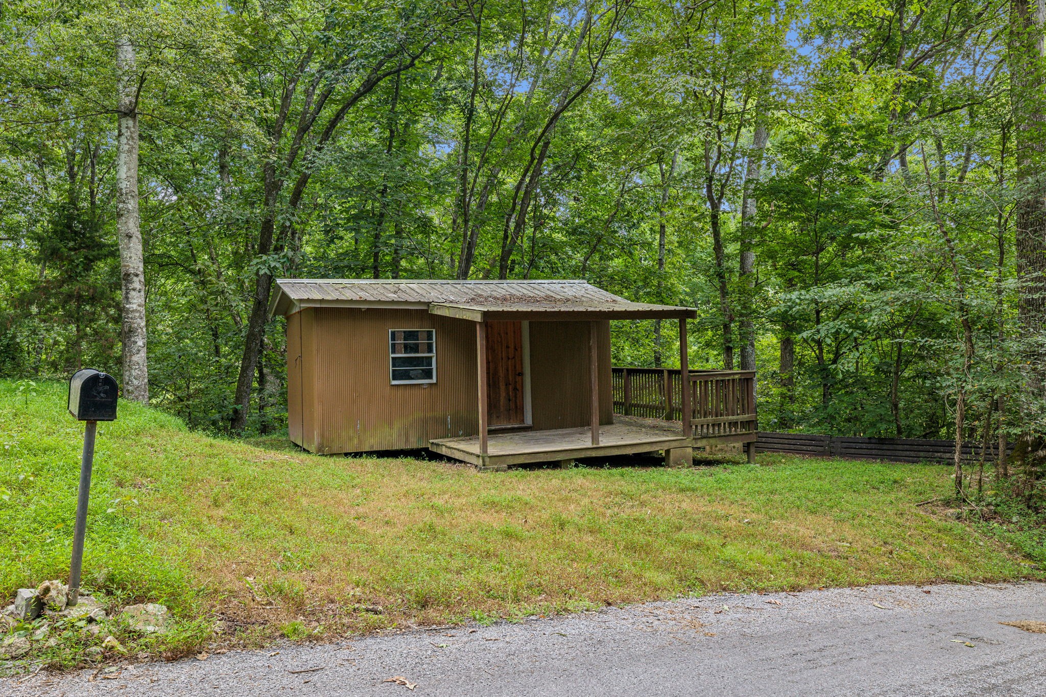 111 Mud Hill Road Dover, TN 37058 - Photo 34 of 62 a front view of a house with a yard and trees