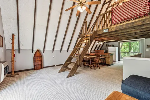 a living room with furniture and a floor to ceiling window