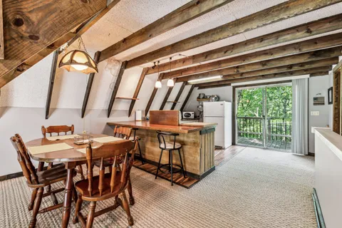 a dining room with furniture and window
